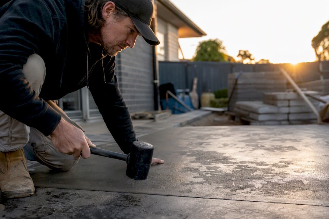 Professional performing tap test on concrete slab