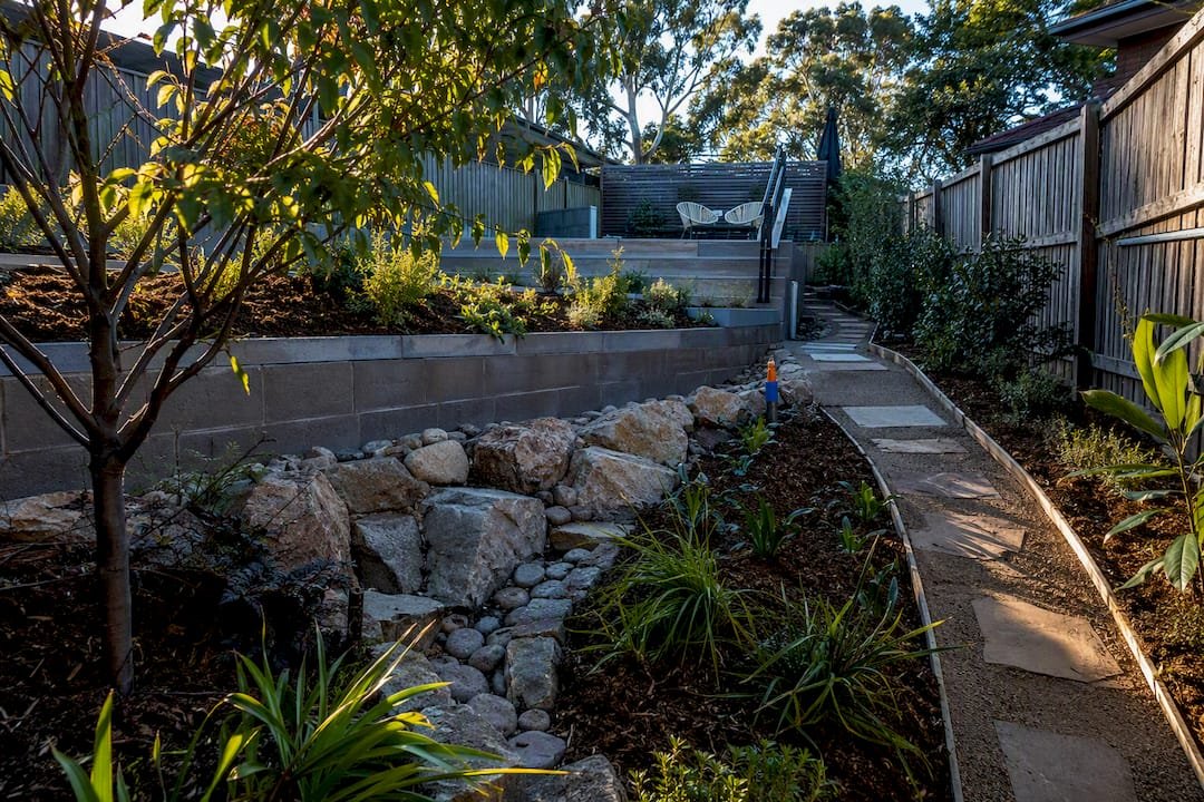 Landscaped backyard with terraced slope solutions